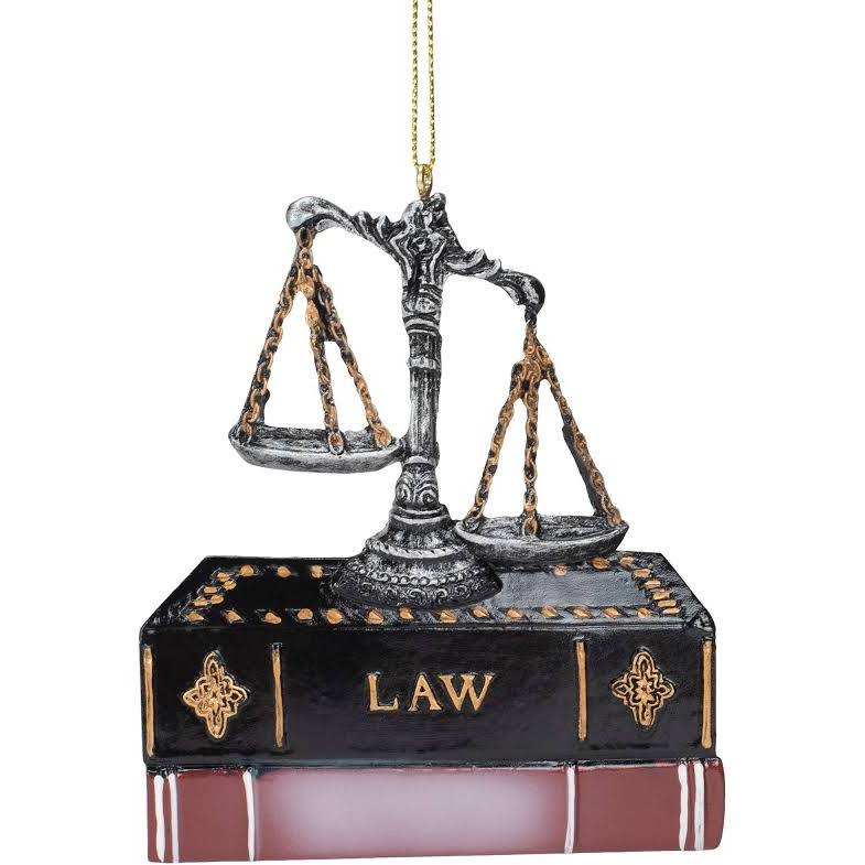 Unbalanced scales of Justice sitting on law books