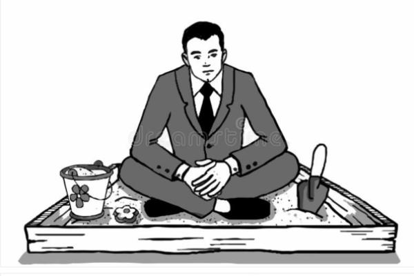 Man in suit sitting in sandbox